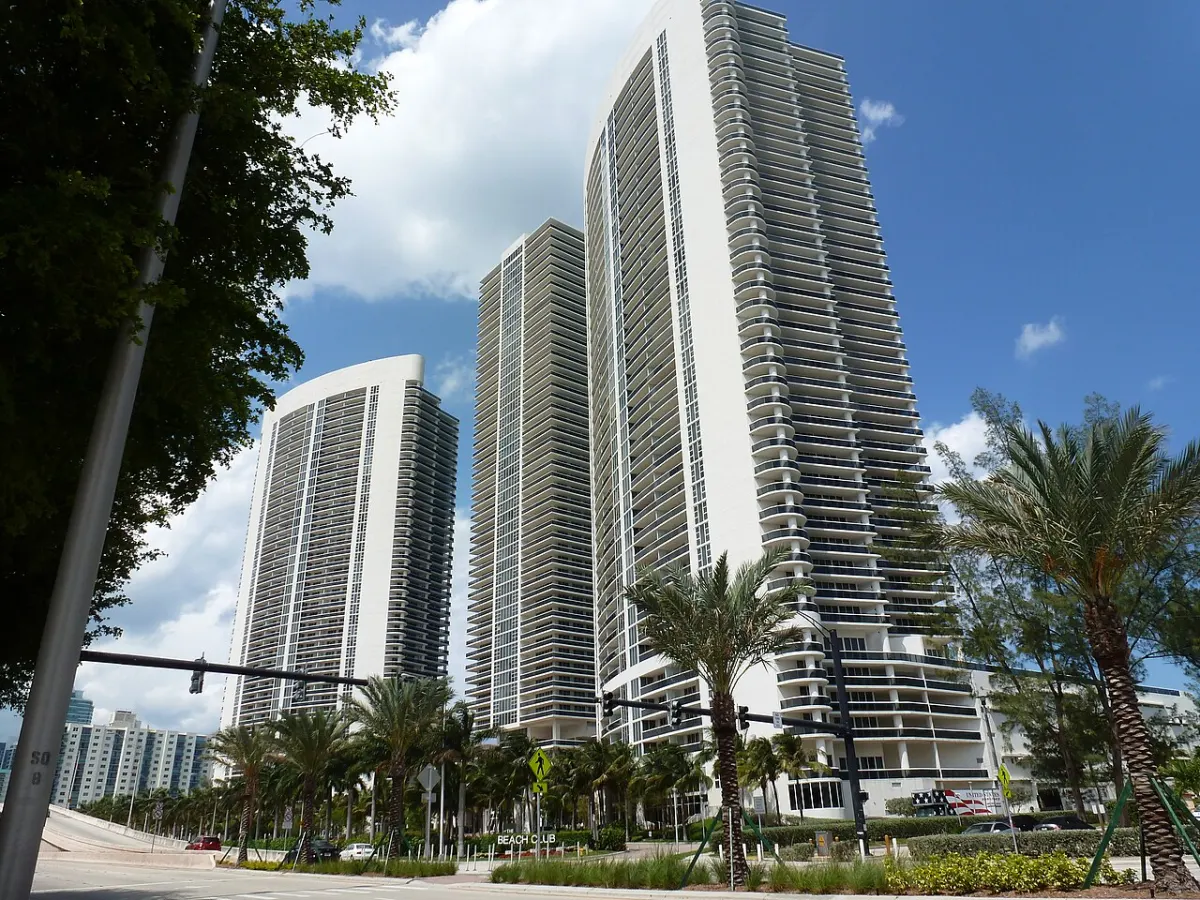 Oceanfront condominium towers with palms along the street in Hallandale Beach