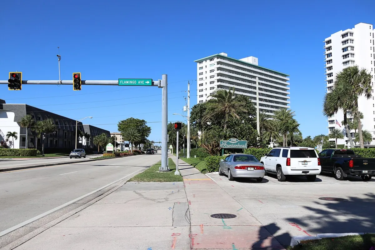 Flamingo Avenue at the main road in Lauderdale-by-the-Sea, with low-rise buildings
