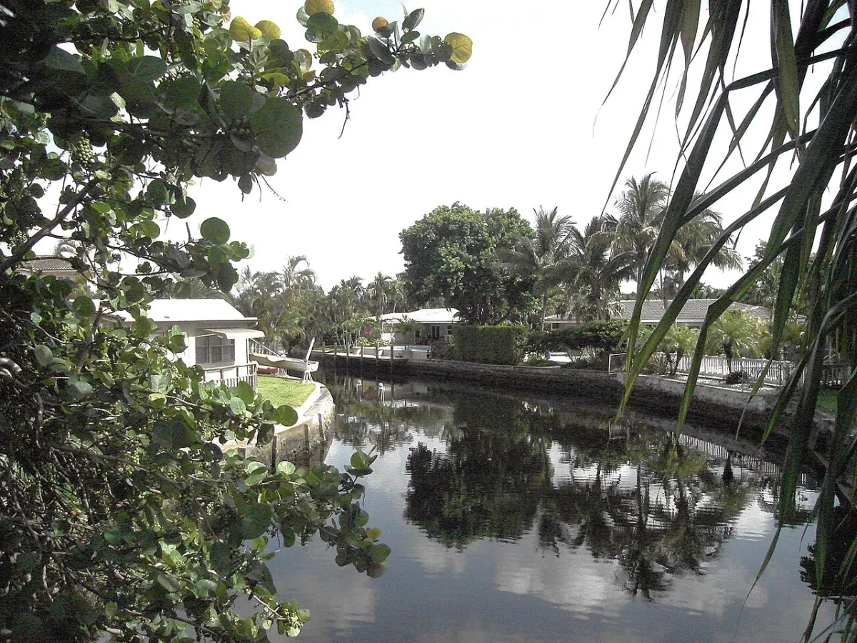 A residential canal in Oakland Park with single-story houses along the bank